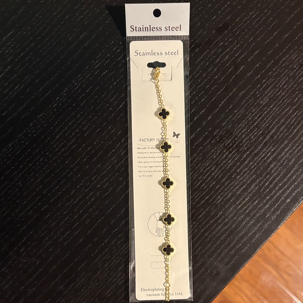 Gold Stainless Steel Bracelet with Black Clover Accents